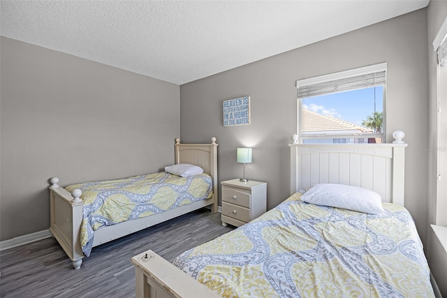 209 Rosso Dr, Davenport, FL 33837 - bedroom with wood finished floors, baseboards, and a textured ceiling