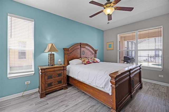 209 Rosso Dr, Davenport, FL 33837 - bedroom with light wood-type flooring, baseboards, and ceiling fan