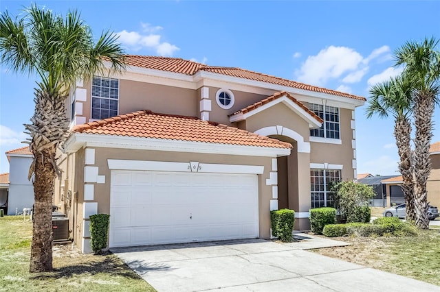 209 Rosso Dr, Davenport, FL 33837 - mediterranean / spanish house with a tile roof, stucco siding, a garage, driveway, and central AC