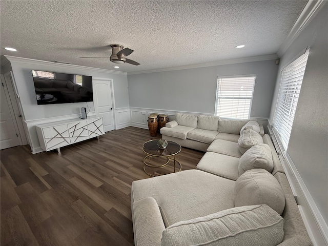 living area with crown molding, a ceiling fan, a textured ceiling, and dark wood-style flooring