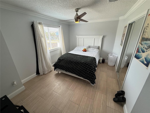 bedroom with crown molding, ceiling fan, baseboards, and light wood-style flooring