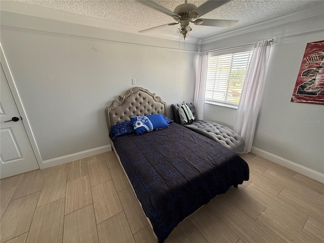 bedroom with baseboards, a textured ceiling, ceiling fan, and light wood-type flooring