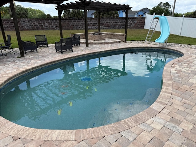 view of pool with a patio, a fenced backyard, a water slide, and a pergola