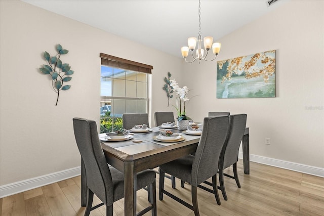 131 Highland Meadows Pl, Davenport, FL 33837 - dining area featuring a chandelier, light wood-type flooring, and baseboards