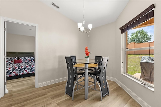 131 Highland Meadows Pl, Davenport, FL 33837 - dining room with light wood-type flooring, a chandelier, and baseboards