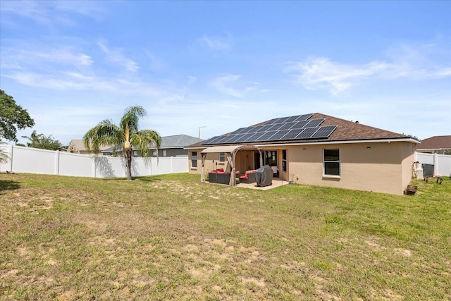 131 Highland Meadows Pl, Davenport, FL 33837 - rear view of house with roof mounted solar panels, a patio area, stucco siding, and a shingled roof
