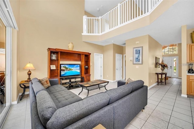 2632 Emerald Island Blvd, Kissimmee, FL 34747 - living area with baseboards, a high ceiling, and light tile patterned flooring