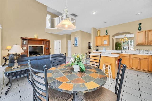 2632 Emerald Island Blvd, Kissimmee, FL 34747 - dining area with light tile patterned floors, arched walkways, recessed lighting, and visible vents