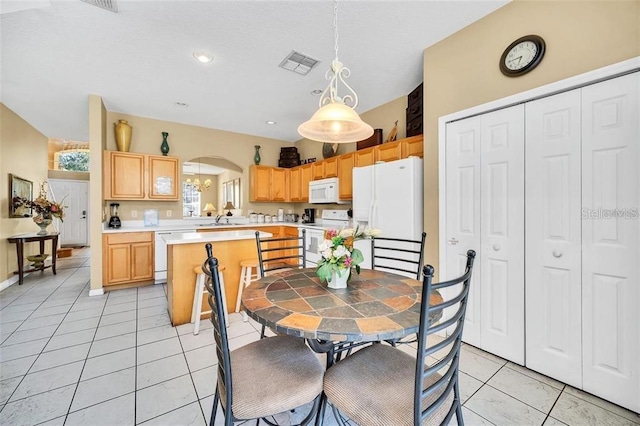 2632 Emerald Island Blvd, Kissimmee, FL 34747 - dining room featuring visible vents, arched walkways, light tile patterned floors, and recessed lighting