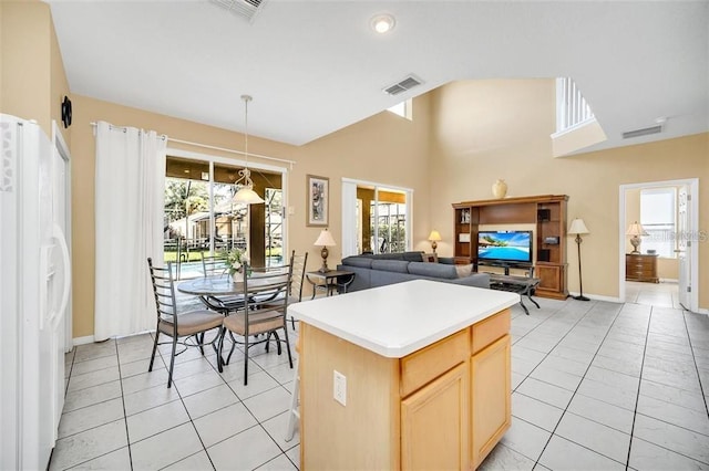 2632 Emerald Island Blvd, Kissimmee, FL 34747 - kitchen with visible vents, light tile patterned floors, and white fridge with ice dispenser