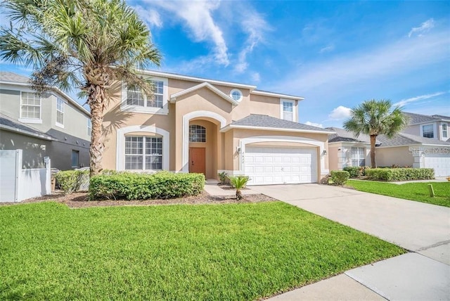 2632 Emerald Island Blvd, Kissimmee, FL 34747 - view of front facade featuring a garage, stucco siding, driveway, and a front lawn