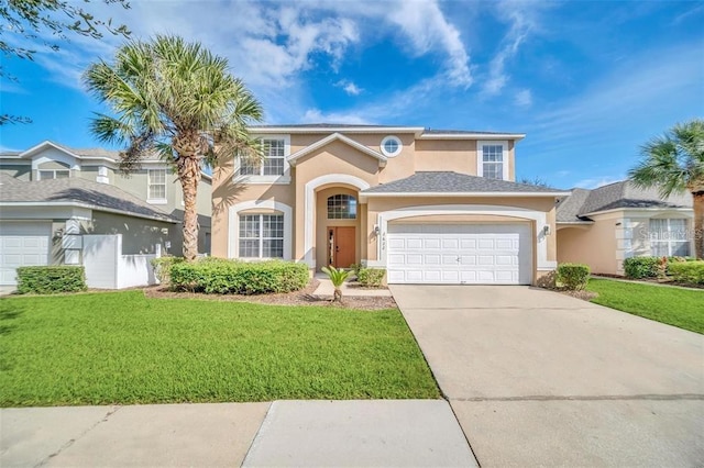 2632 Emerald Island Blvd, Kissimmee, FL 34747 - view of front facade with an attached garage, driveway, a front lawn, and stucco siding