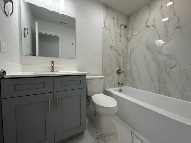 705 Wood Ln, Kissimmee, FL 34759 - bathroom with toilet, marble finish floor, vanity, shower / bathing tub combination, and a textured wall