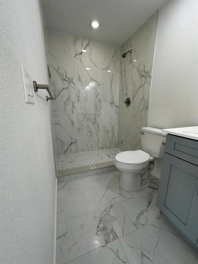 705 Wood Ln, Kissimmee, FL 34759 - bathroom featuring toilet, vanity, a textured wall, and a marble finish shower