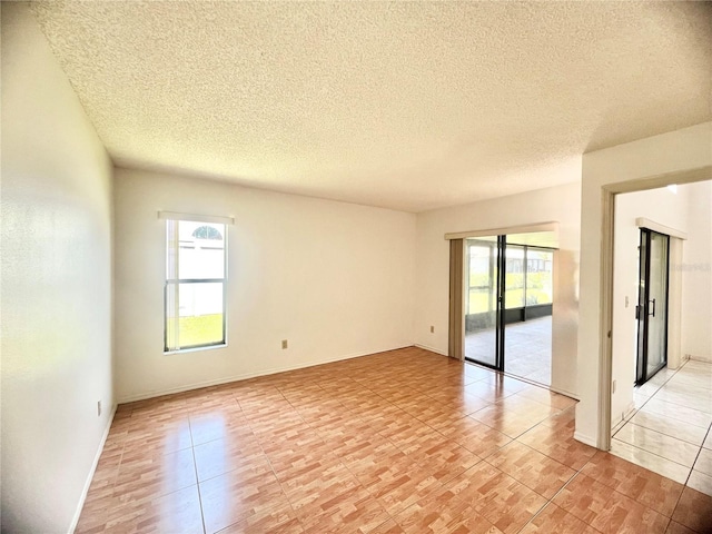 849 Long Bay Ct, Kissimmee, FL 34741 - spare room with healthy amount of natural light, a textured ceiling, and light tile patterned floors