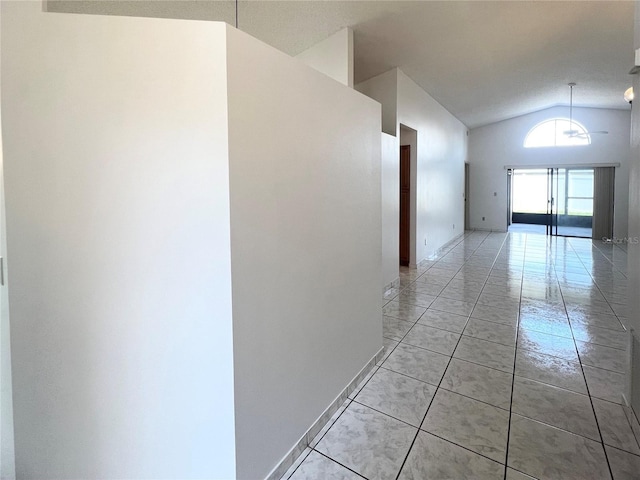 849 Long Bay Ct, Kissimmee, FL 34741 - hall with lofted ceiling, light tile patterned floors, and baseboards