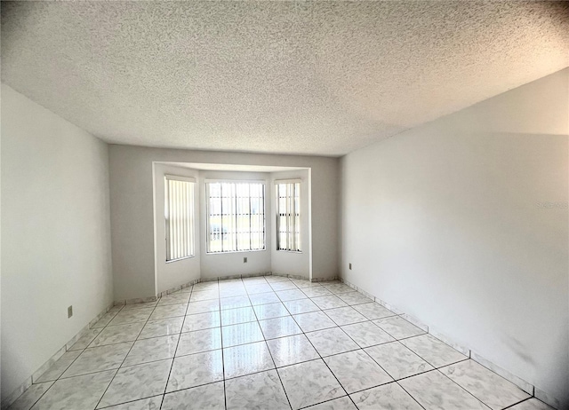 849 Long Bay Ct, Kissimmee, FL 34741 - empty room featuring a textured ceiling and light tile patterned floors