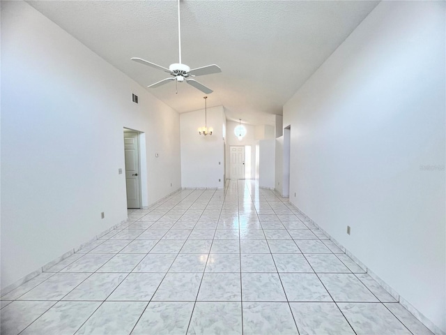 849 Long Bay Ct, Kissimmee, FL 34741 - unfurnished room with ceiling fan, light tile patterned floors, a chandelier, and high vaulted ceiling