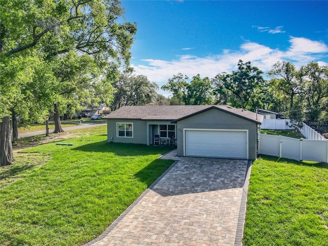 ranch-style home featuring fence, a front lawn, a garage, stucco siding, and driveway