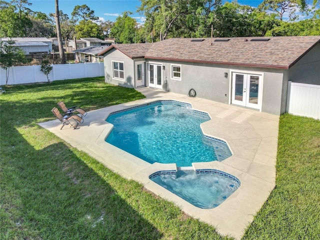 view of swimming pool featuring a fenced backyard, french doors, a patio area, a lawn, and an in ground hot tub