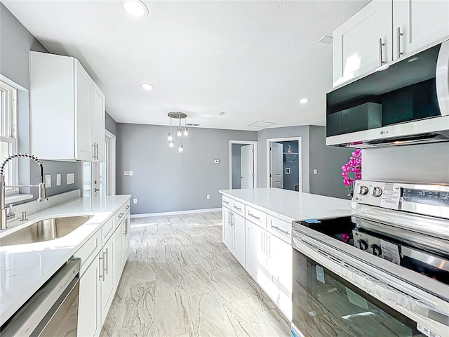 kitchen with appliances with stainless steel finishes, a sink, marble finish floor, recessed lighting, and white cabinetry