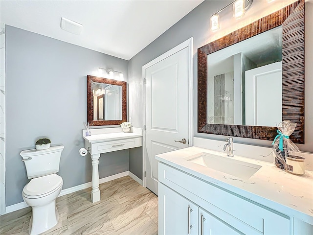 full bathroom featuring baseboards, a sink, and toilet