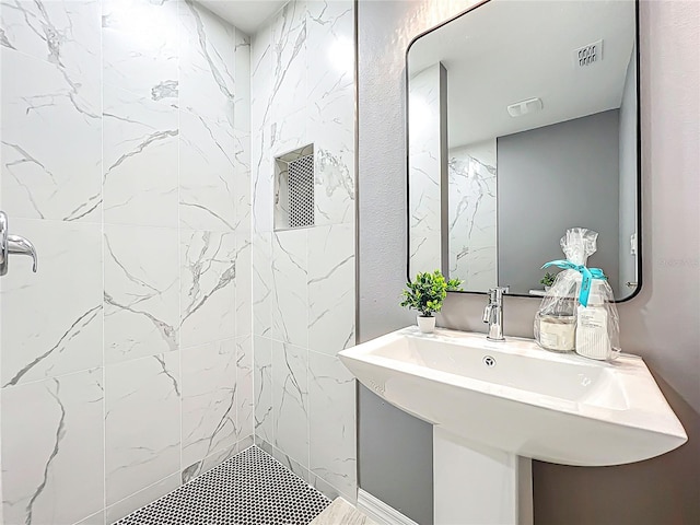 bathroom with a tile shower