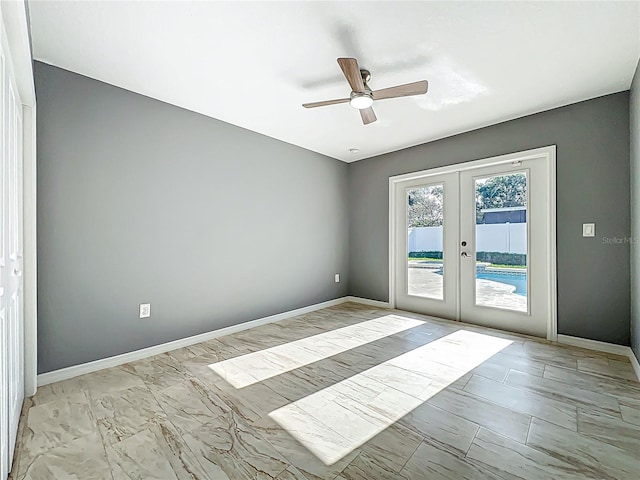 empty room with baseboards, ceiling fan, french doors, and marble finish floor