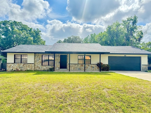 4385 NE 2nd Ct, Ocala, FL 34479 - single story home with a shingled roof, stone siding, a garage, a front yard, and driveway