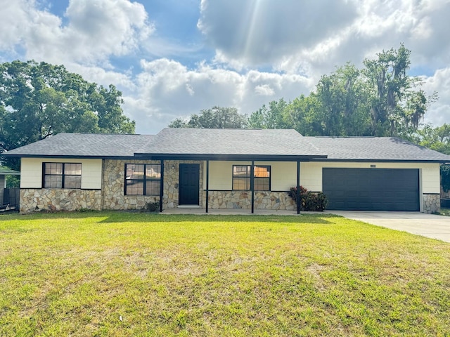 4385 NE 2nd Ct, Ocala, FL 34479 - ranch-style home featuring a shingled roof, an attached garage, stone siding, a front yard, and driveway