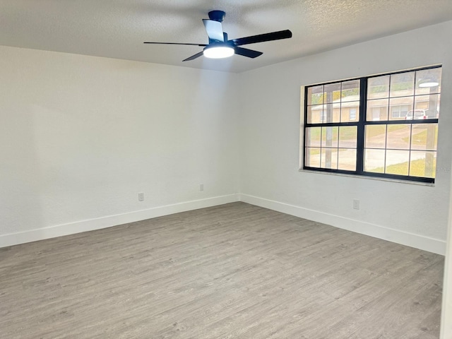 4385 NE 2nd Ct, Ocala, FL 34479 - spare room featuring baseboards, a textured ceiling, ceiling fan, and wood finished floors