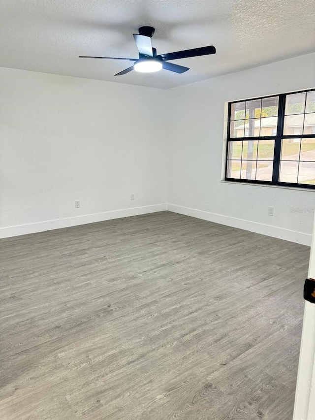 4385 NE 2nd Ct, Ocala, FL 34479 - empty room with baseboards, a textured ceiling, ceiling fan, and wood finished floors