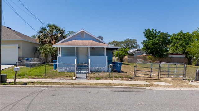 31 Cedar St, Haines City, FL 33844 - view of front facade with a porch, a fenced front yard, and a gate