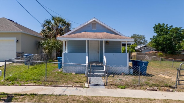31 Cedar St, Haines City, FL 33844 - view of front of home with a porch, a fenced front yard, a gate, and a garage