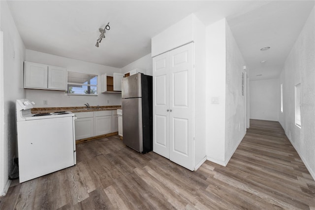 31 Cedar St, Haines City, FL 33844 - kitchen with open shelves, white electric range oven, freestanding refrigerator, and light wood-style flooring