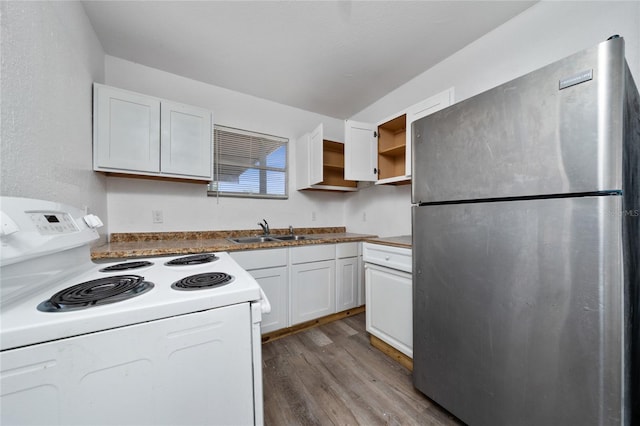 31 Cedar St, Haines City, FL 33844 - kitchen featuring open shelves, freestanding refrigerator, wood finished floors, electric stove, and a sink