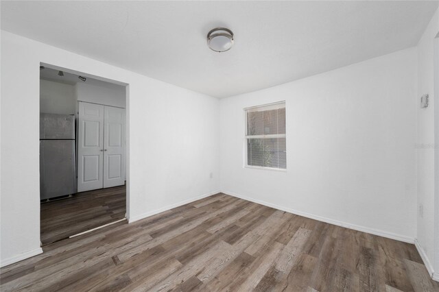 31 Cedar St, Haines City, FL 33844 - spare room featuring baseboards and wood finished floors