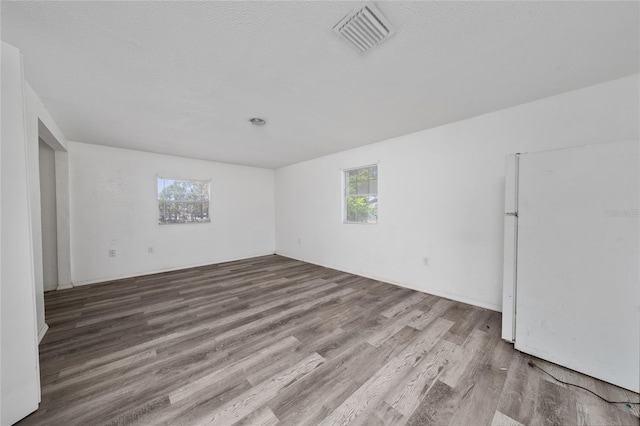 31 Cedar St, Haines City, FL 33844 - spare room featuring visible vents, plenty of natural light, and wood finished floors