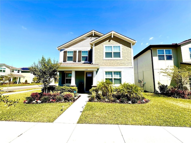 craftsman inspired home with stucco siding and a front yard