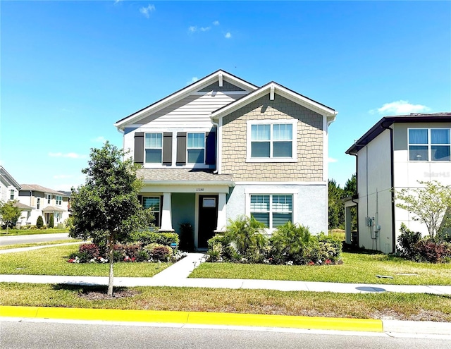 view of front of house featuring stucco siding and a front yard