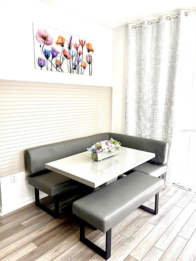 dining area featuring breakfast area and wood finished floors