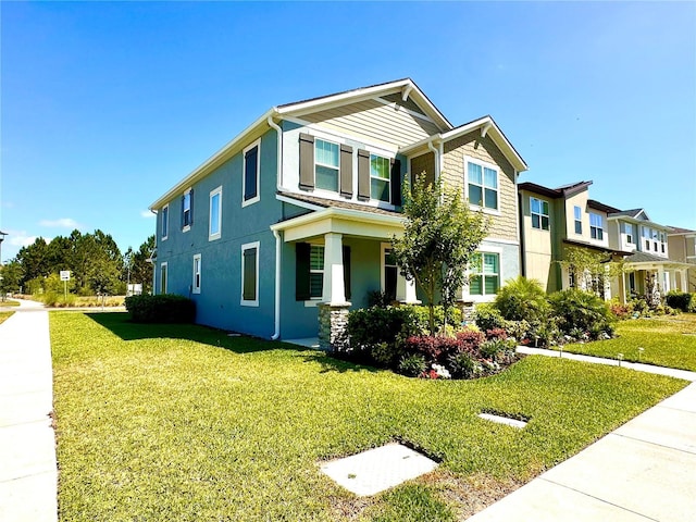 view of front of home with a residential view, stucco siding, and a front yard