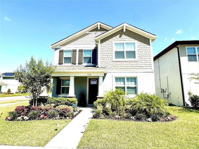 view of front of home featuring a front yard and stucco siding