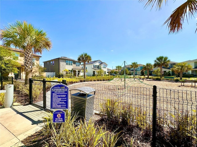view of community with a residential view and fence