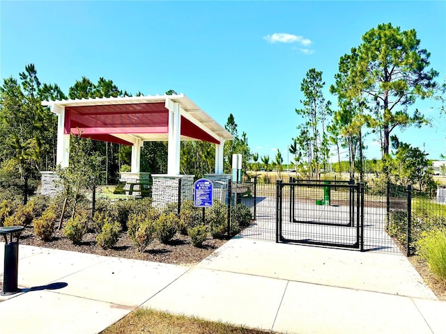 view of property's community with a gate and fence