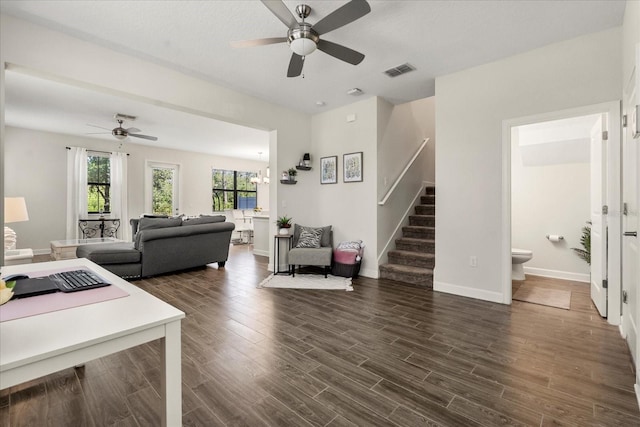 living room featuring visible vents, plenty of natural light, ceiling fan, and stairway