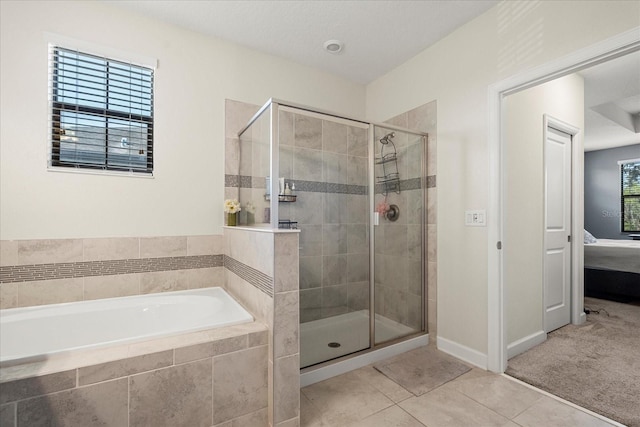 ensuite bathroom with a bath, tile patterned flooring, a stall shower, baseboards, and connected bathroom