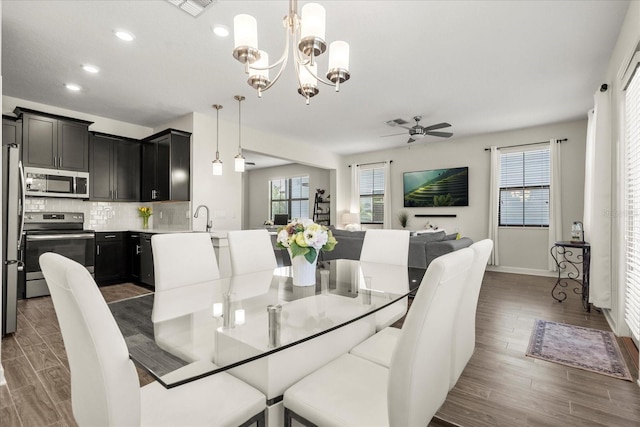 dining room featuring recessed lighting, ceiling fan with notable chandelier, dark wood-style floors, and visible vents