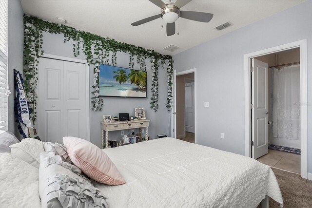 bedroom with connected bathroom, ceiling fan, carpet floors, visible vents, and a closet
