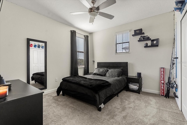 bedroom with baseboards, light colored carpet, and ceiling fan